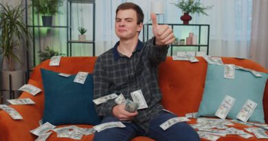 Homem sentado no sofá contando dinheiro, representando formas de ganhar dinheiro em casa.